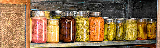 jars of preserved vegetables in a pie safe