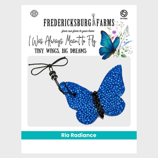 Blue butterfly charm with text about Fredericksburg Farms on a white background